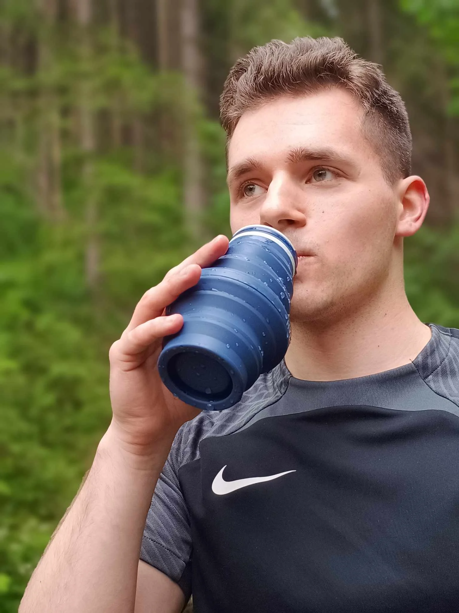 Jeremiah Kowalski using a reusable water bottle outdoors during real-world use
