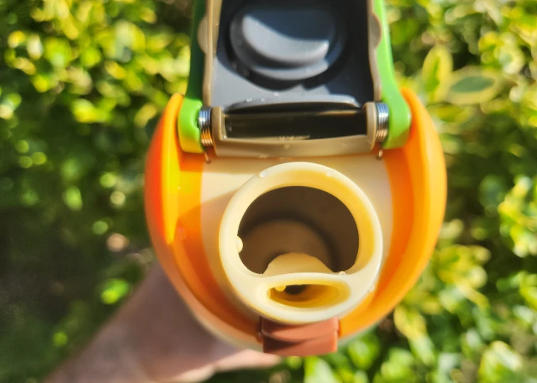 Close-up of the Owala FreeSip water bottle spout, highlighting its unique design with a circular opening and a smaller oval sip hole.