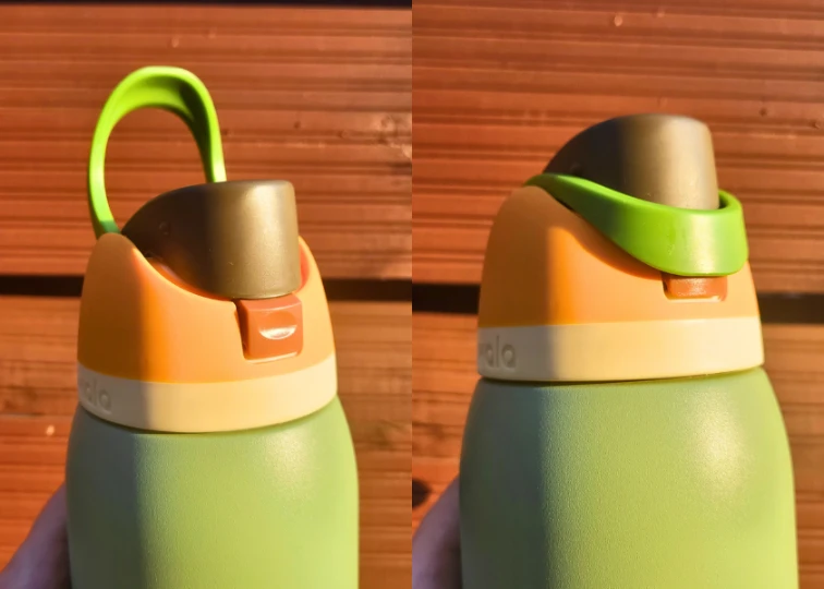 Close-up of a green Owala FreeSip water bottle lid with the handle covering the button for enhanced leakproofness.