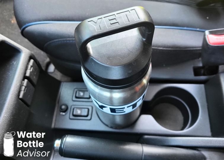 YETI Rambler 26 oz bottle sitting in a car cup holder