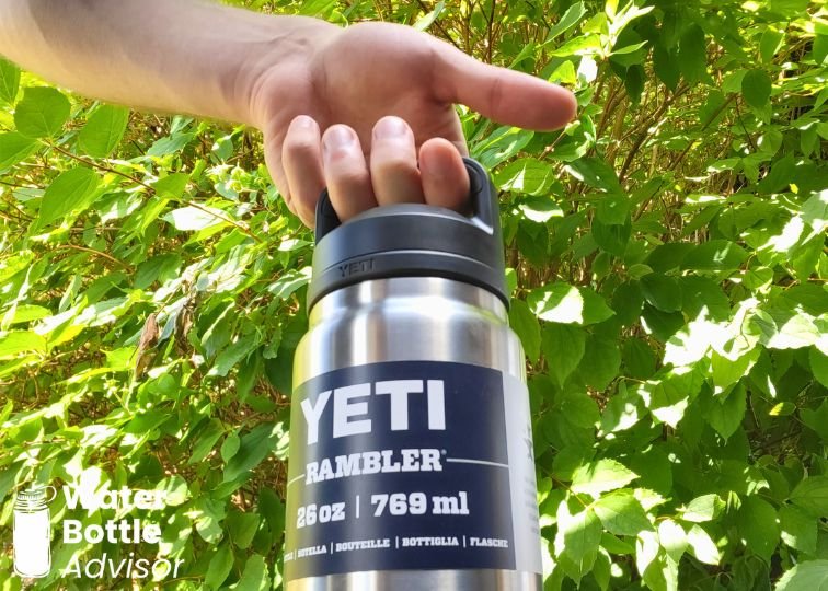 YETI Rambler 26 oz bottle being carried by its handle outdoors