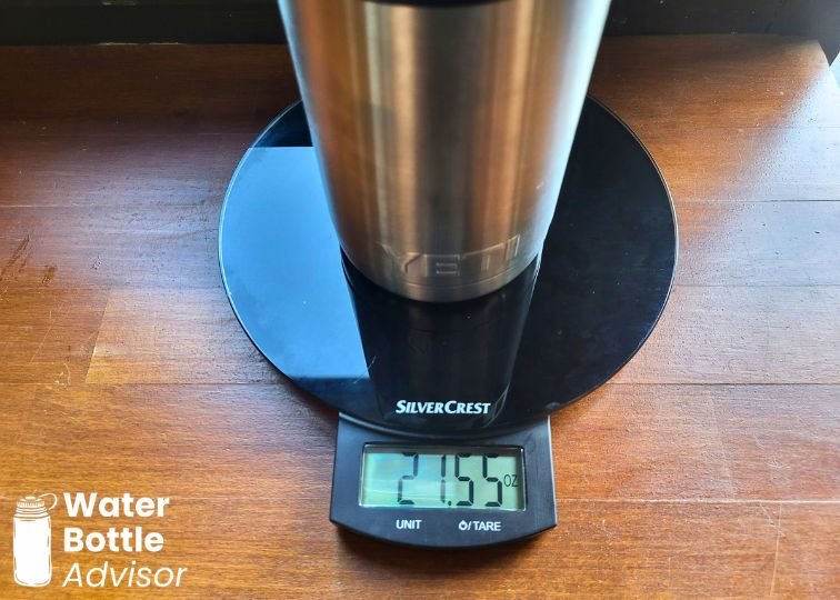 YETI Rambler 26 oz bottle weighed empty on a digital kitchen scale showing 21.55 oz