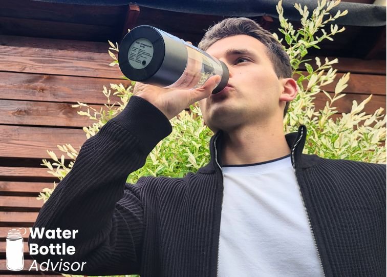 Jeremiah Kowalski drinking from the Piurify Hydrogenator hydrogen water bottle outdoors