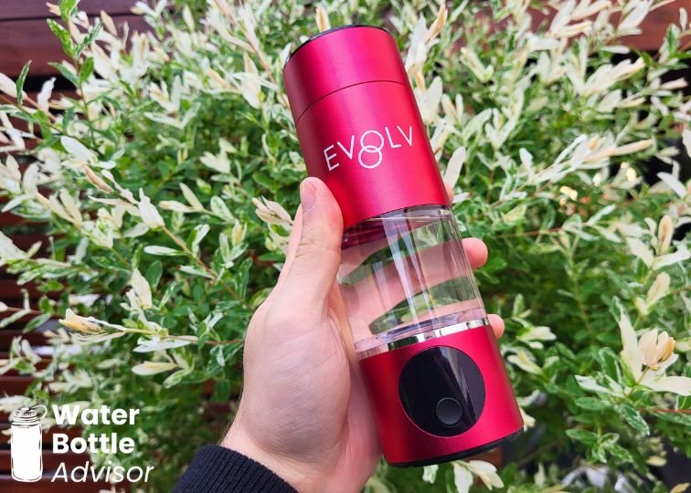 Jeremiah Kowalski holding the red EVOLV hydrogen water bottle outdoors