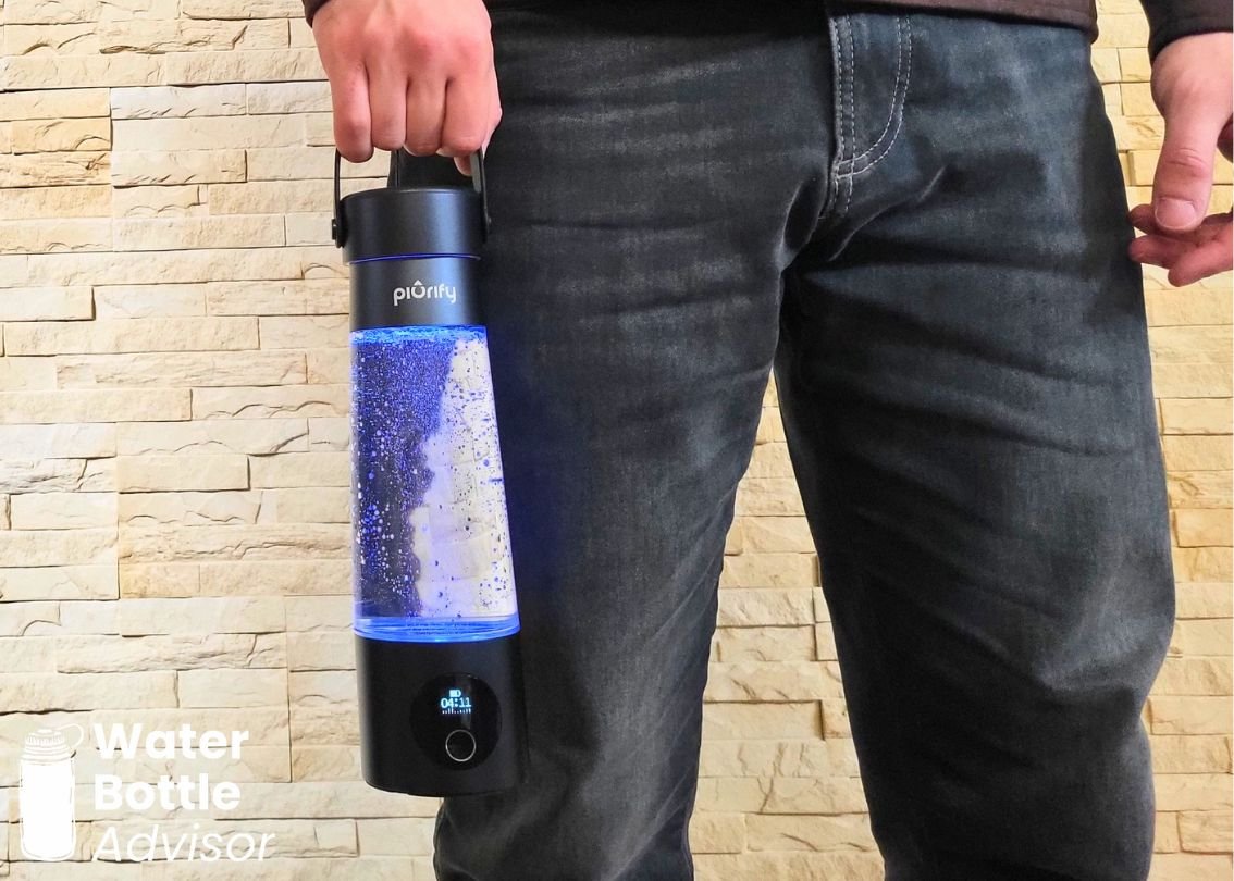Jeremiah Kowalski holding the Piurify Hydrogenator hydrogen water bottle by its handle