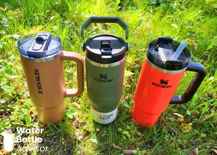 Stanley IceFlow Tumbler 30 oz, Stanley ProTour 30 oz, and Stanley Quencher 30 oz standing on grass outdoors