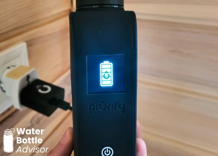 Piurify Flask hydrogen water bottle charging via USB-C with battery status displayed on the screen