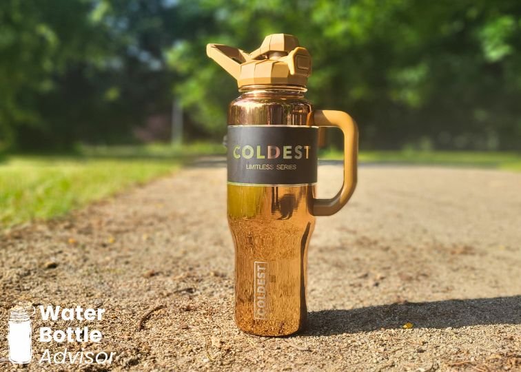 Coldest Tumbler 36 oz standing outdoors on a gravel path
