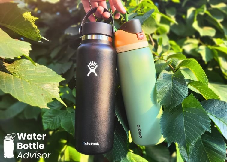 Hydro Flask 40 oz and Owala FreeSip 40 oz bottles hanging in direct sunlight outdoors
