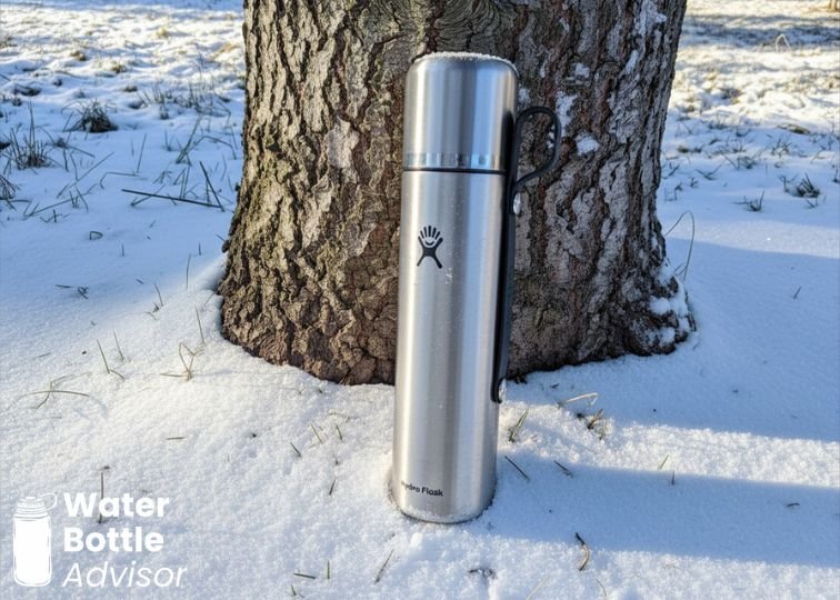 Hydro Flask Trail Series Lightweight 24 oz orange water bottle sitting in a car cup holder
