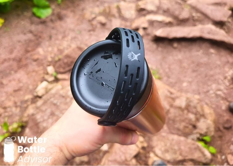 Close-up of the Hydro Flask Trail Series Lightweight 24 oz bottle flex cap while being held on a hiking trail