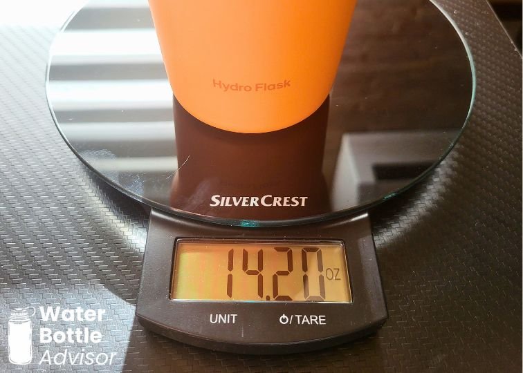 Hydro Flask Travel Bottle 24 oz on a kitchen scale showing a weight of 14.20 oz