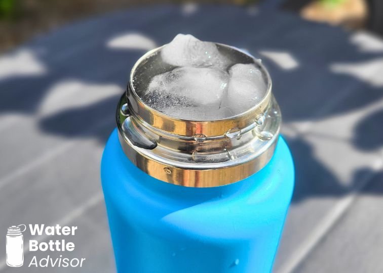 Close-up of a Hydro Flask Wide Mouth 32 oz blue water bottle filled with ice cubes