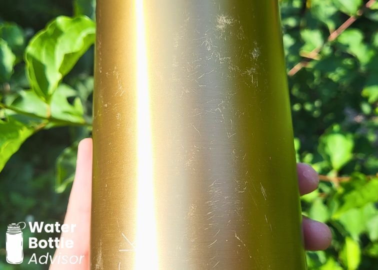 Close-up of scratches on the gold Iron Flask 40 oz bottle finish