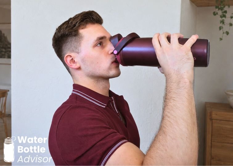 Jeremiah Kowalski drinking from the Owala FreeSip Sway 30 oz bottle indoors