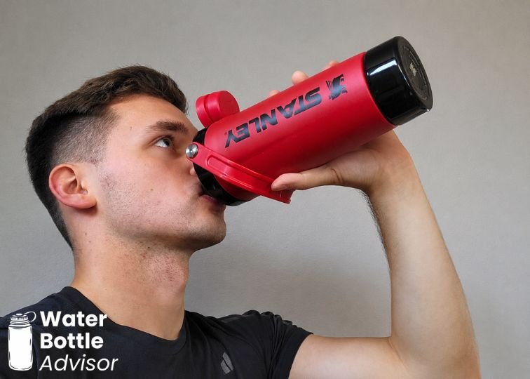 Jeremiah Kowalski drinking from the Stanley Vitalize Shaker bottle indoors