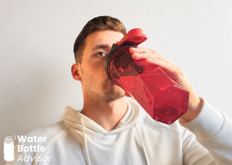 Jeremiah Kowalski drinking from the YETI Yonder shaker bottle indoors