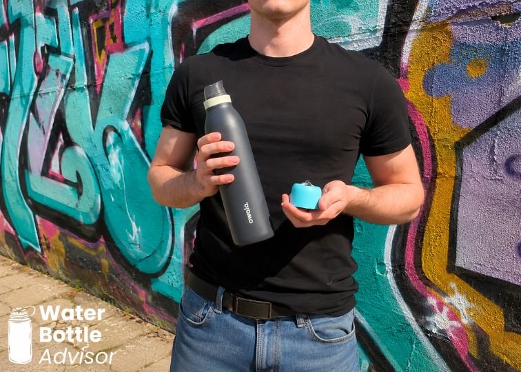 Jeremiah Kowalski holding the Owala FreeSip Twist 24 oz bottle and cap outdoors