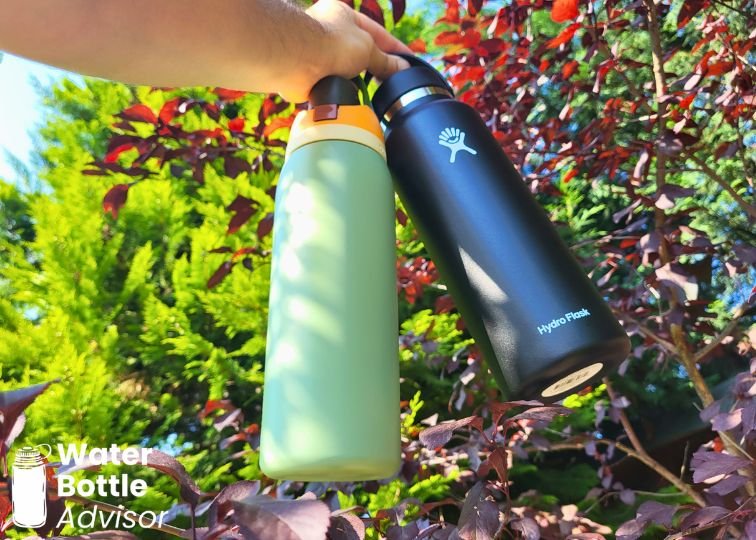 Owala FreeSip 40 oz and Hydro Flask 40 oz bottles being held outdoors side by side