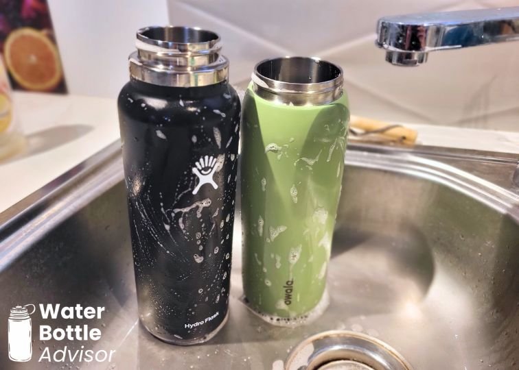 Owala FreeSip 40 oz and Hydro Flask 40 oz bottles standing in a kitchen sink with soap on the exterior