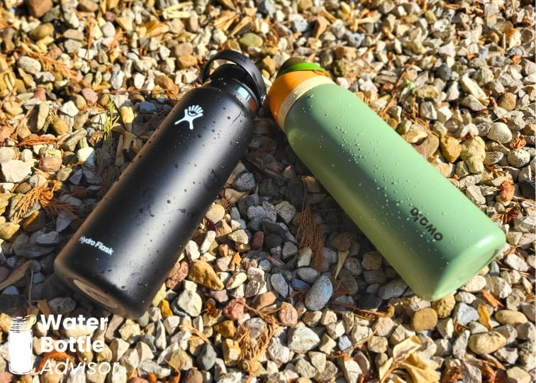 Owala FreeSip 40 oz and Hydro Flask 40 oz bottles lying on gravel outdoors