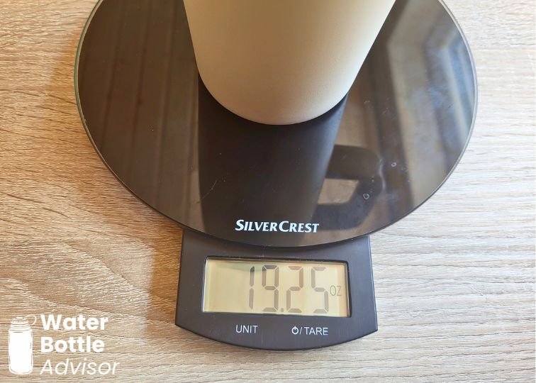 Owala FreeSip Tumbler 30 oz weighed empty on a digital kitchen scale showing 19.25 oz