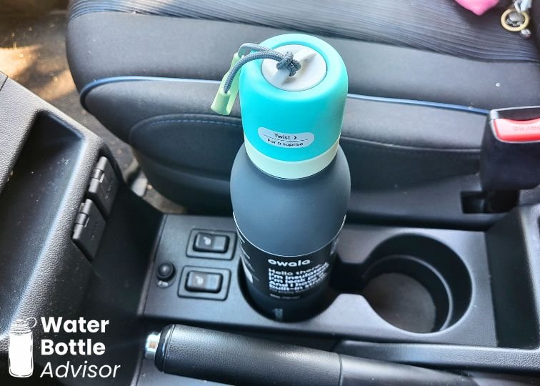 Owala FreeSip Twist 24 oz bottle sitting in a car cup holder