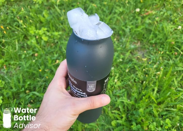 Owala FreeSip Twist 24 oz bottle packed with ice outdoors