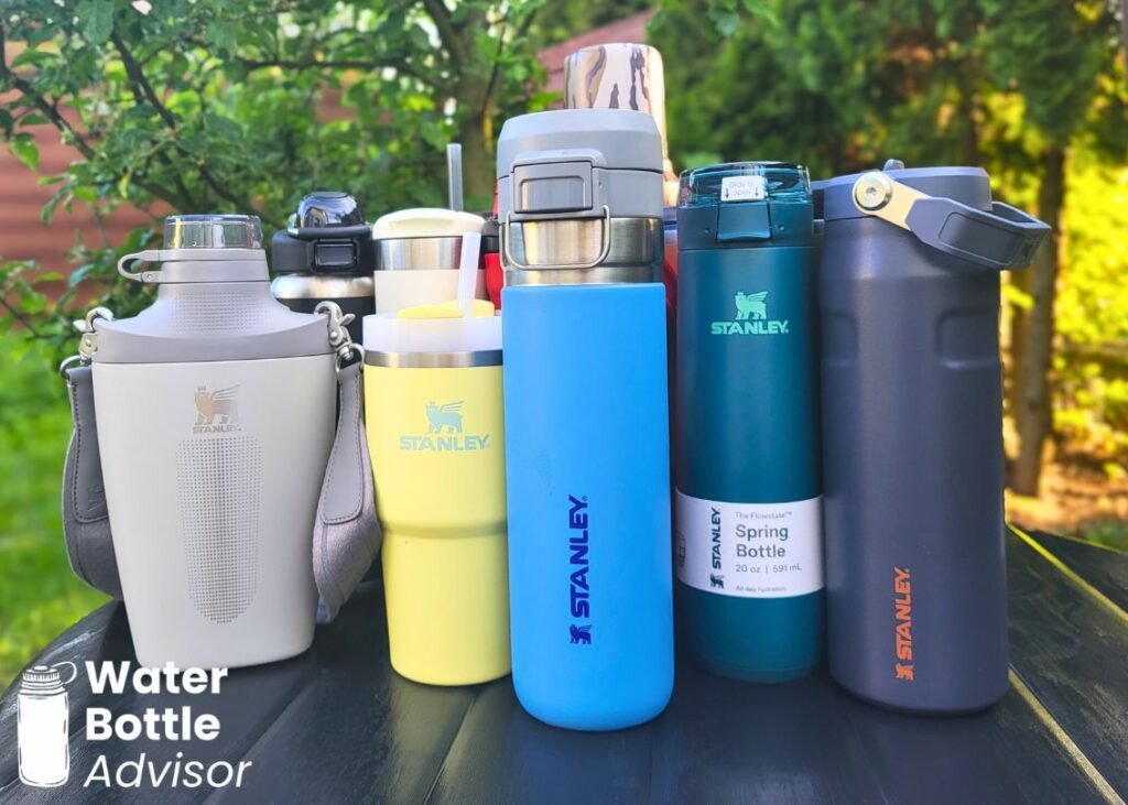 Stanley bottles and tumblers lined up outdoors for size and design comparison