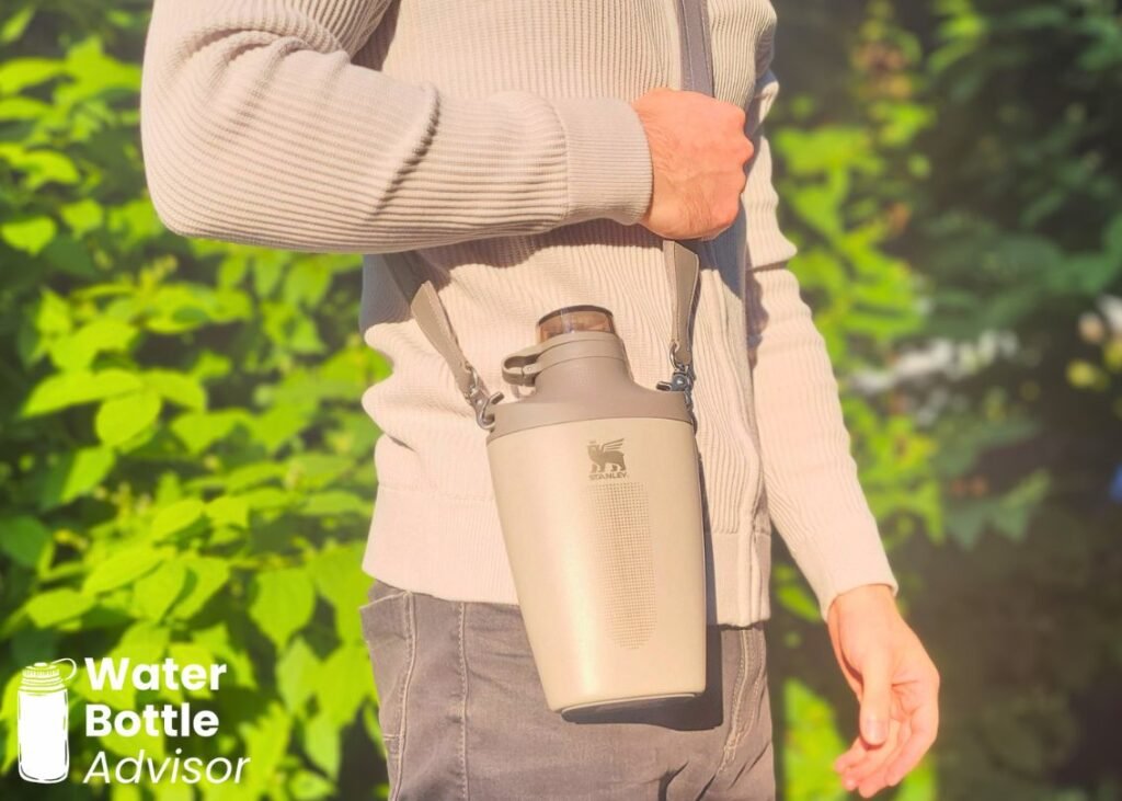 Stanley Cross Bottle 23 oz worn with a crossbody strap outdoors
