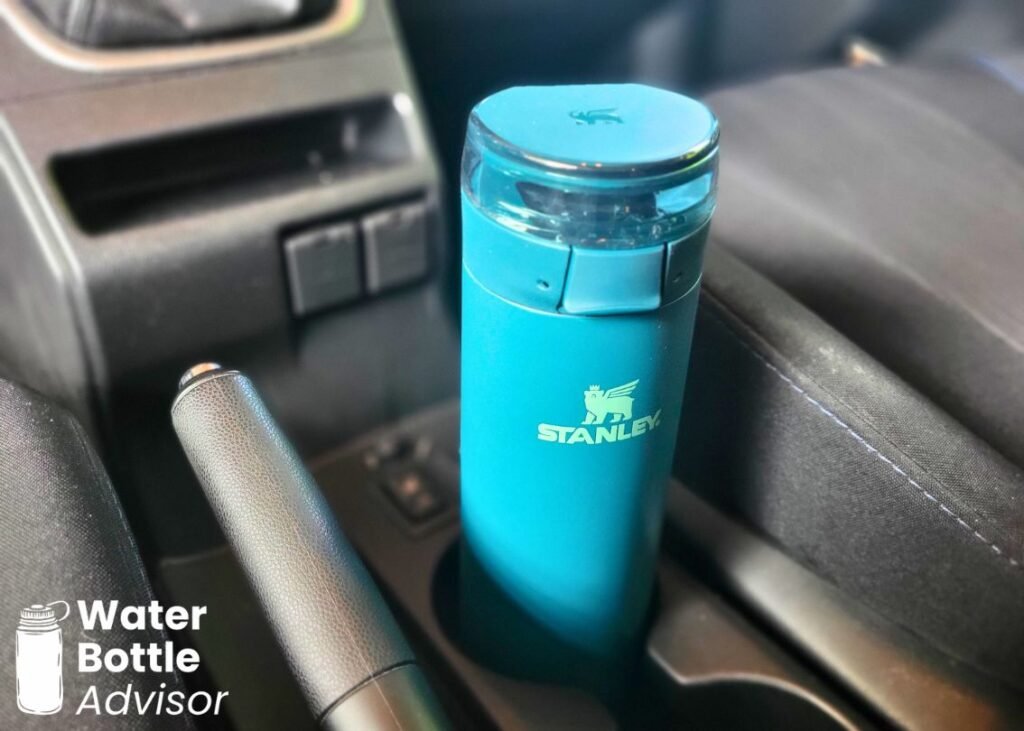 Stanley FlowState Spring Bottle 20 oz sitting in a car cup holder