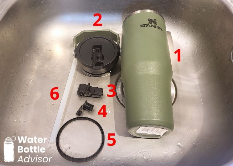 Stanley IceFlow 30 oz tumbler disassembled into parts for cleaning in a sink