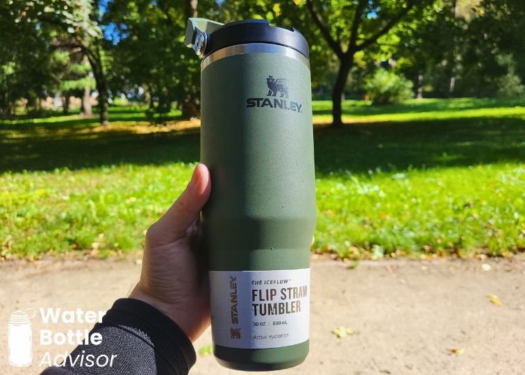 Stanley IceFlow Tumbler 30 oz being held outdoors in a park