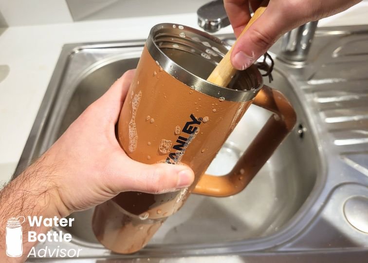 Stanley ProTour Tumbler 30 oz being cleaned with a brush in a sink