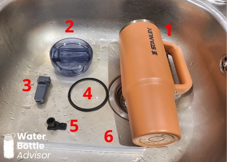 Stanley ProTour Tumbler 30 oz disassembled into six parts for cleaning in a sink