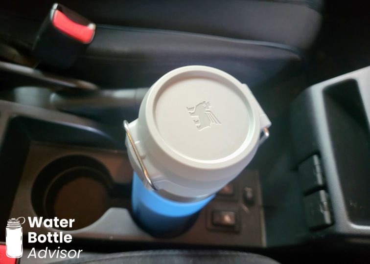Stanley Quick-Flip Go 24 oz bottle sitting in a car cup holder