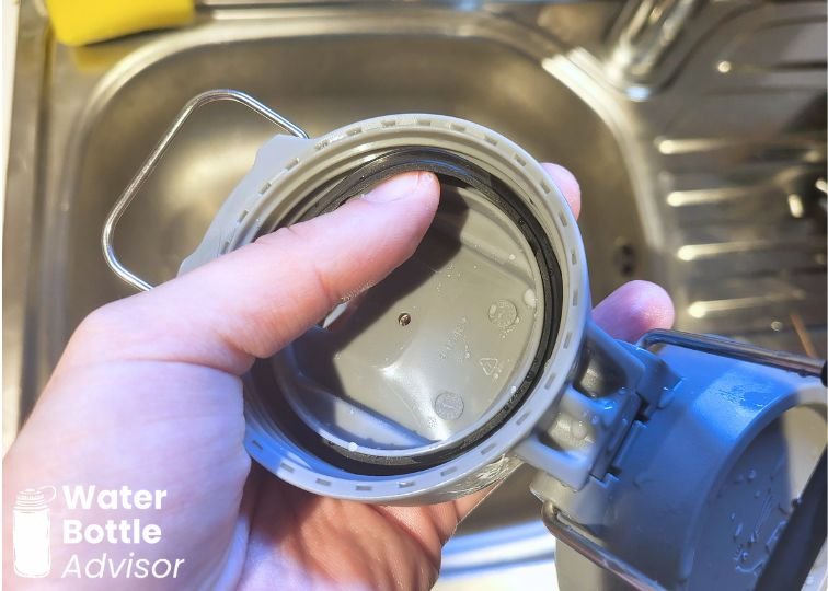 Close-up of the Stanley Quick-Flip Go 24 oz cap showing the silicone gasket being removed for cleaning