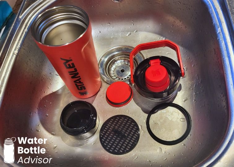 Stanley Vitalize Shaker Bottle disassembled into six parts for cleaning in a sink
