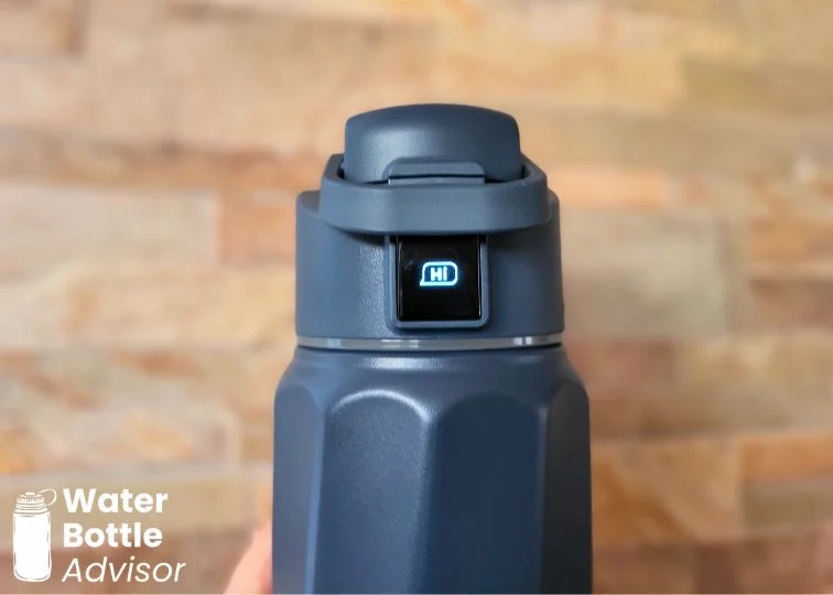 Close-up of the WaterH BOOST 32 oz smart water bottle OLED screen display showing the hydration status indicator