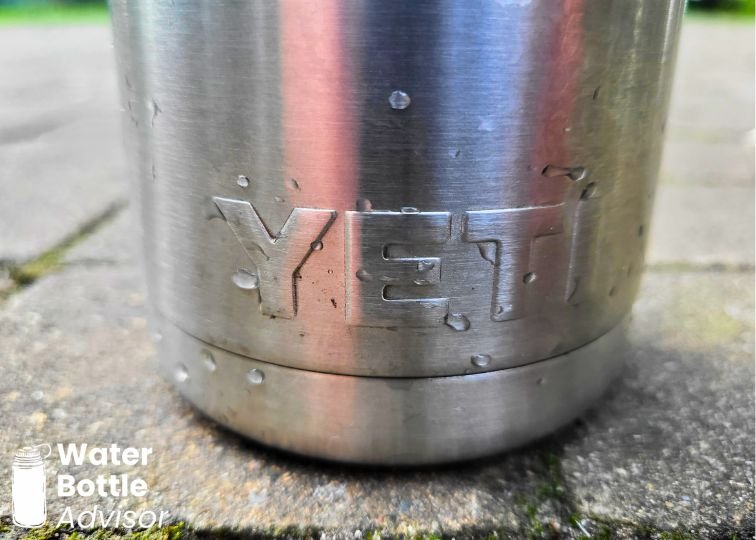 Close-up of the YETI Rambler 26 oz stainless steel water bottle base showing the durable metal bottom and embossed YETI logo