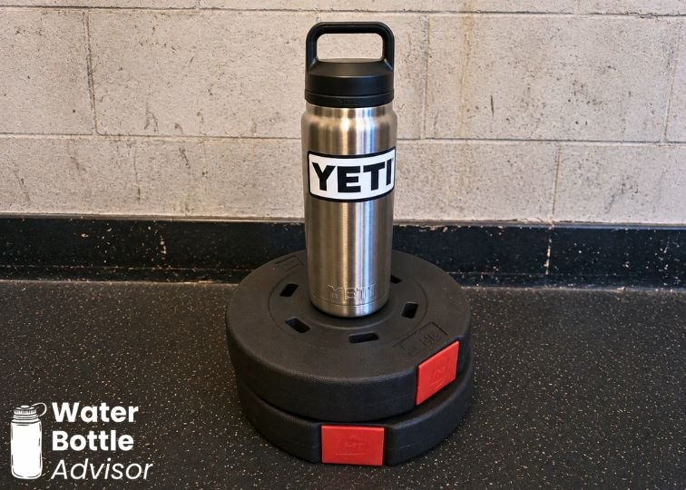 YETI Rambler 26 oz stainless steel water bottle standing on gym equipment