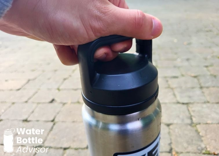 YETI Rambler Chug Cap being opened using the handle for extra leverage