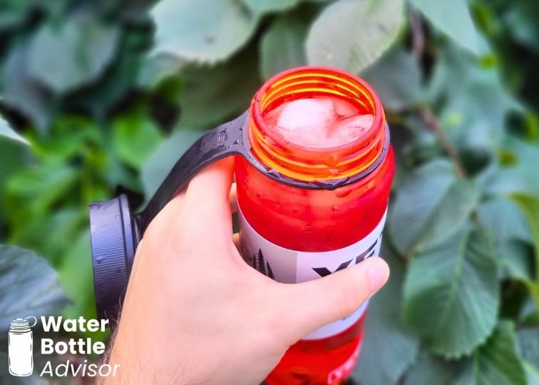 Close-up of the YETI Yonder 25 oz red plastic water bottle with ice cubes inside