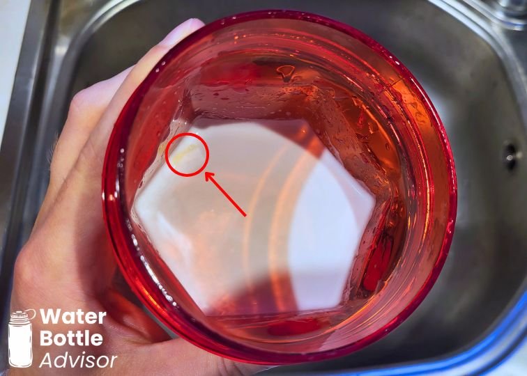 YETI Yonder shaker bottle showing liquid after a mixing test with a small unmixed spot marked inside