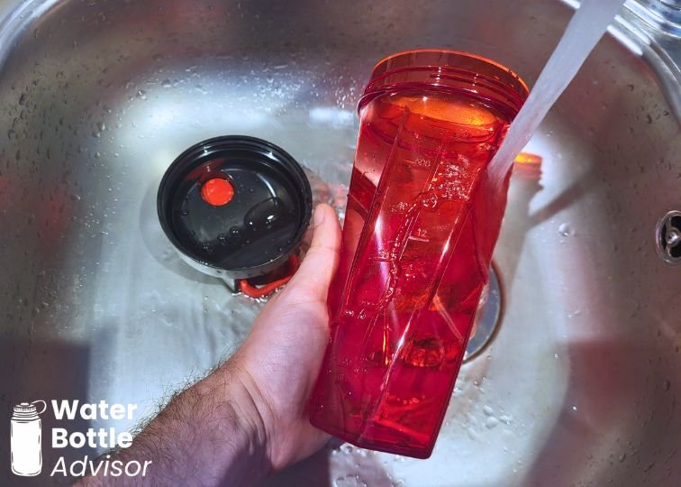 YETI Yonder shaker bottle being washed under running water in a sink